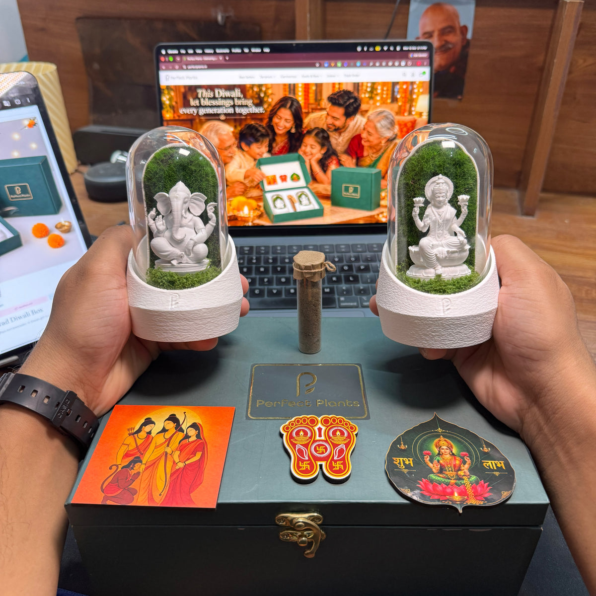 Green Diwali gift box held in two hands