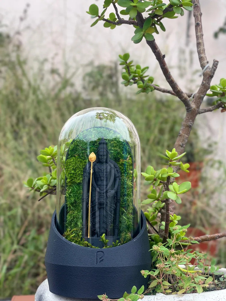 Black-based figurine dome photographed in natural light