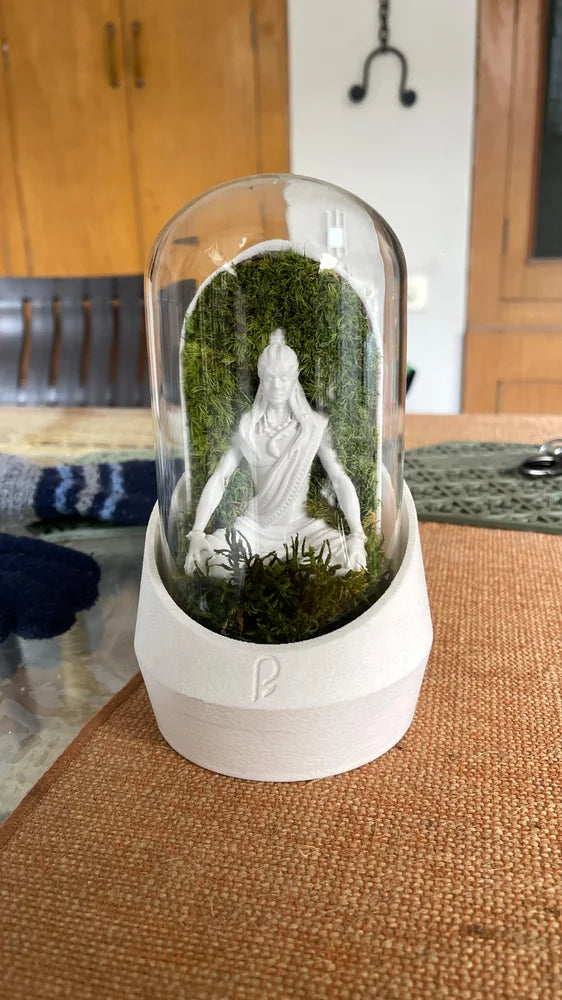 White figurine dome on a fabric-covered table
